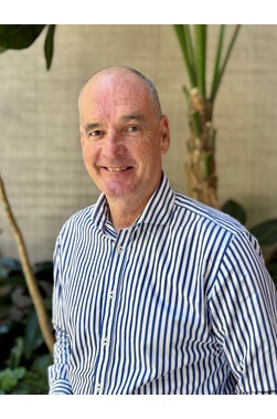 Person in a suit smiling