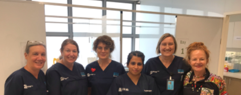 six nurses standing side by side posing for a photo